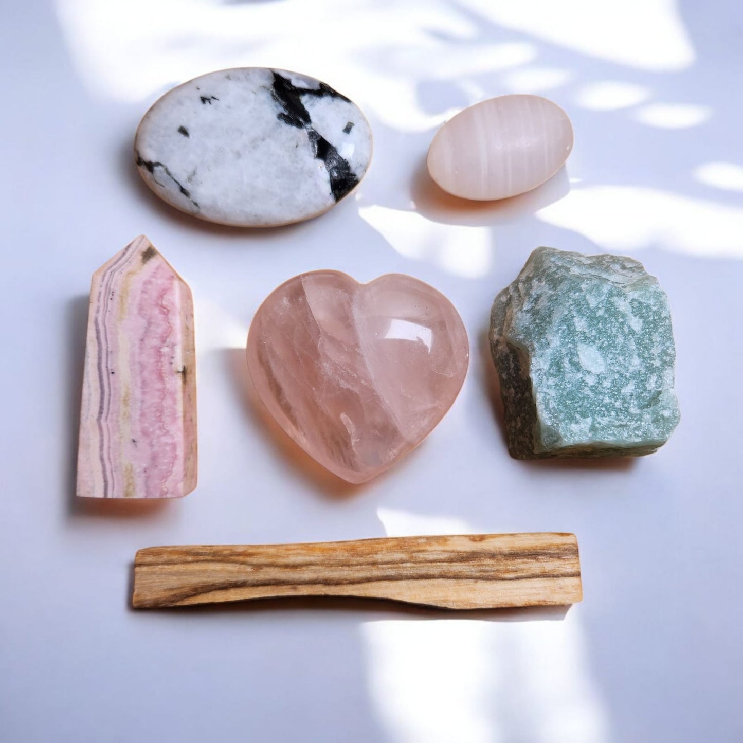 Sacred Gems – Love Crystal Kit – Standard Edition crystals (Rose Quartz,Mangano Calcite, Rhodonite, Green Aventurine, Moonstone) arranged on soft blush fabric [variant:standard]

