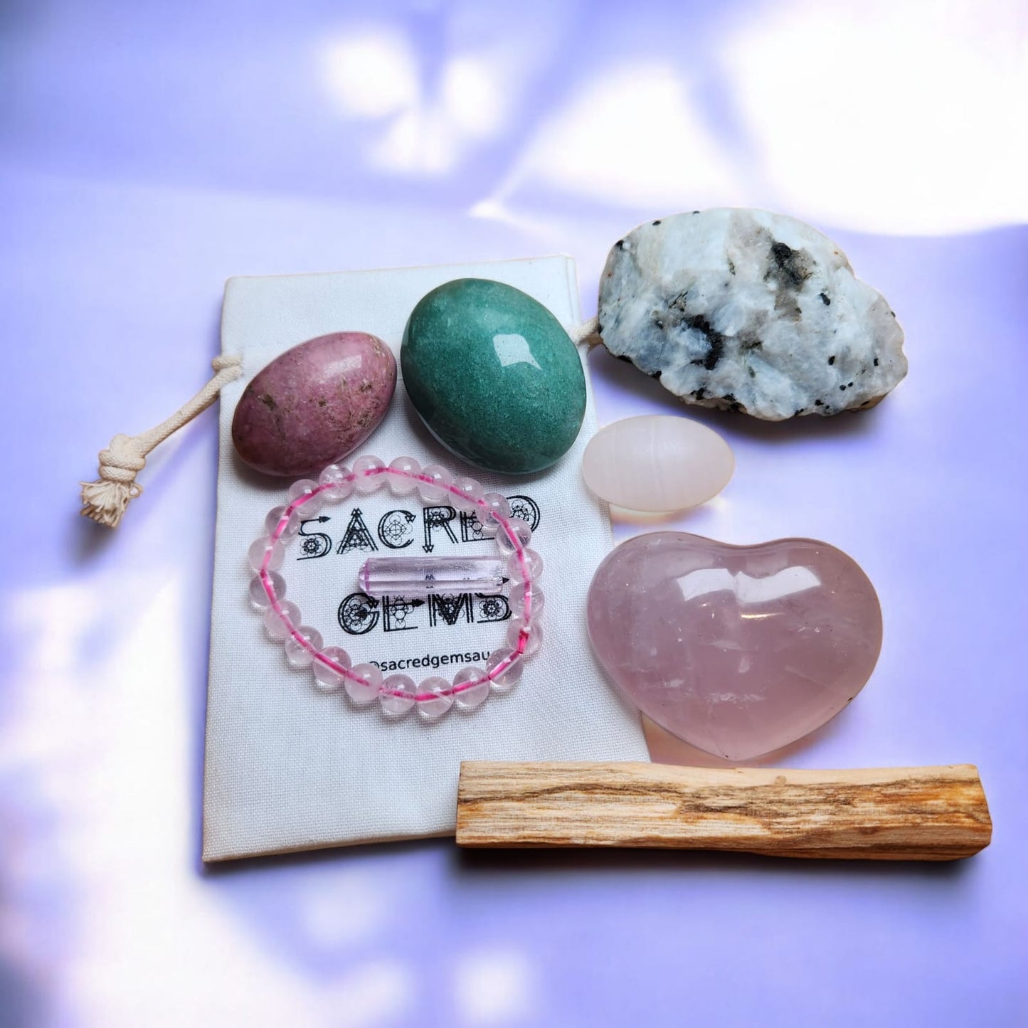 Sacred Gems – Love Crystal Kit – Deluxe Edition full contents flat lay including Kunzite and Rose Quartz bracelet [variant:deluxe]
