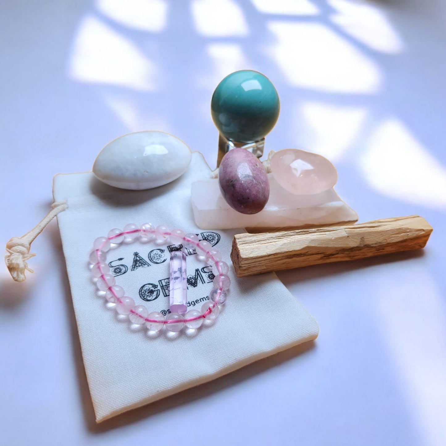 Sacred Gems – Love Crystal Kit – Deluxe Edition full contents flat lay including Kunzite and Rose Quartz bracelet [variant:deluxe]
